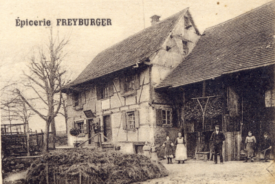 Where one can see the entrance to the grocery store, separate from the entrance to the residence.